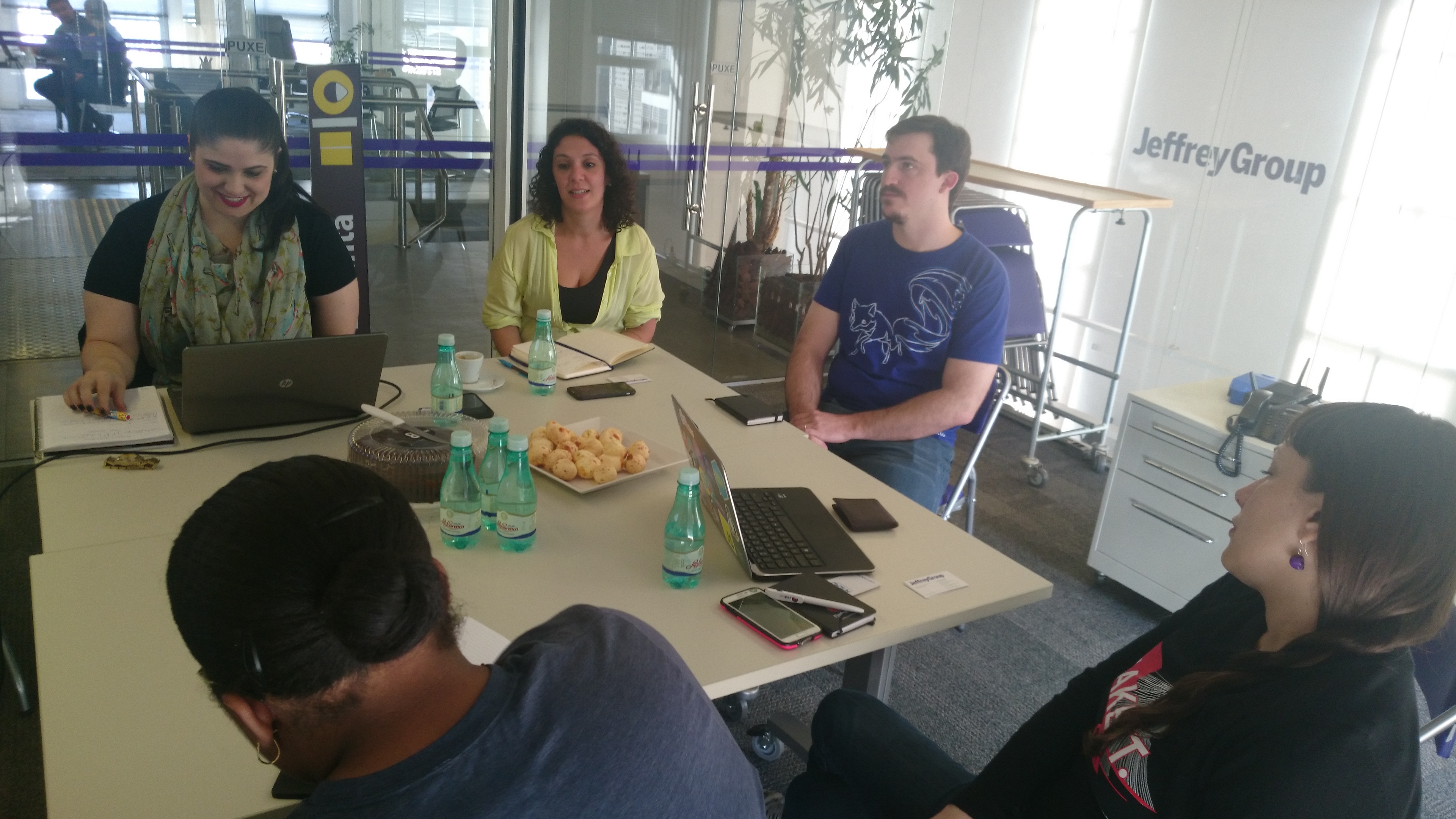 Image of people sitting at table, writing